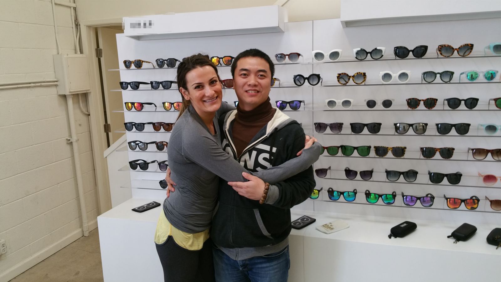 Customers reviewing the sunglasses display