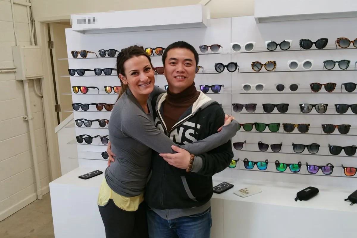 Customers reviewing the sunglasses display